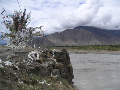 [prayer flags over river]